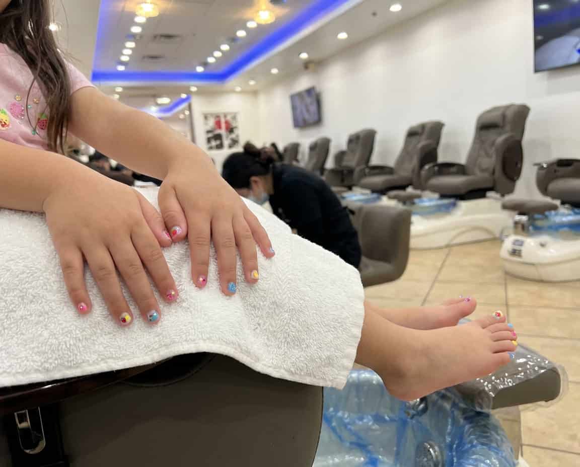Child receiving professional manicure and pedicure at Zen Nail Lounge Upland.